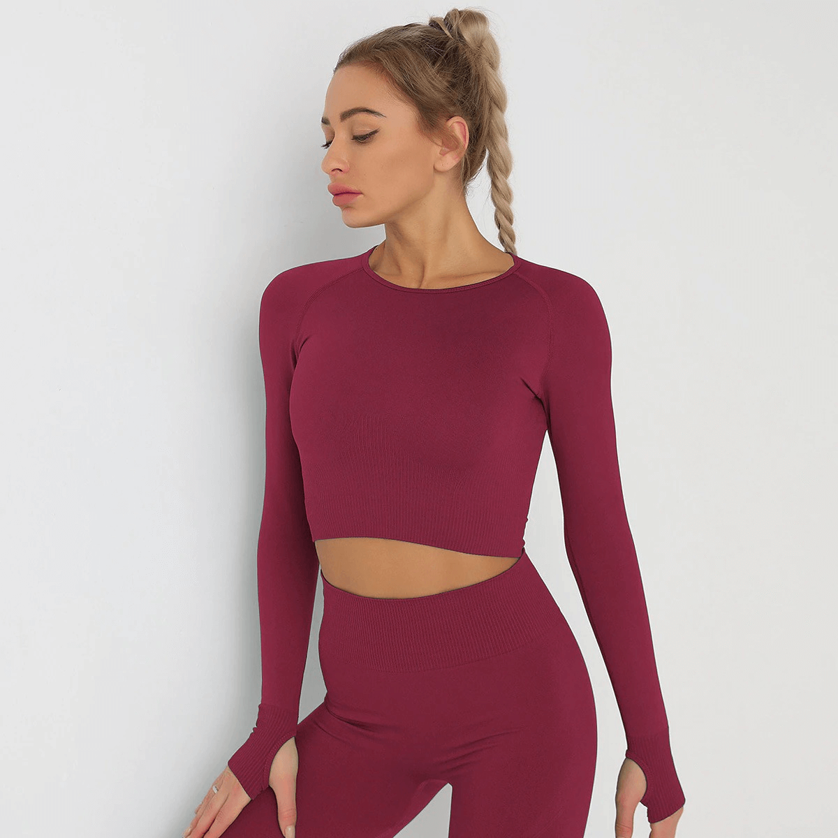 Fashionable long sleeve crop top for women in burgundy, made of breathable nylon and spandex, ideal for yoga and running.